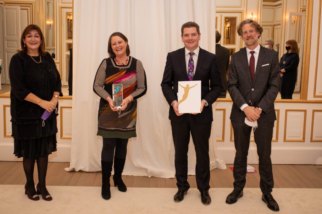 Winners holding the Award